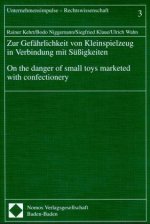 Zur Gefährlichkeit von Kleinspielzeug in Verbindung mit Süßigkeiten. On the danger of small toys marketed with confectionery