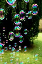 Soap Bubbles: A Soap Bubble Is an Extremely Thin Film of Soapy Water Enclosing Air That Forms a Hollow Sphere with an Iridescent Sur